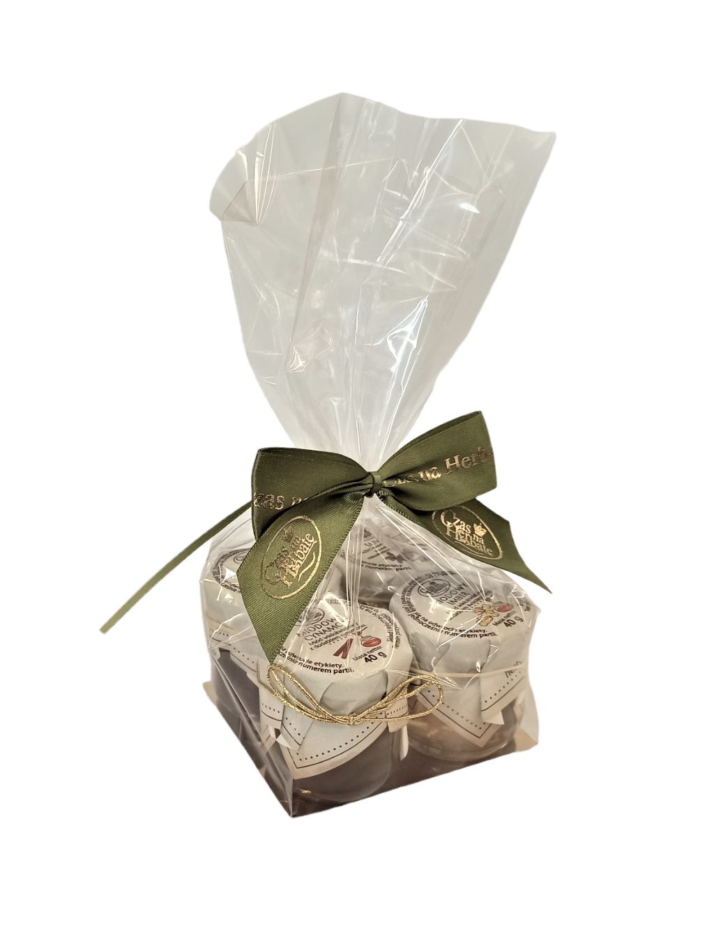 Cztery słoiczki zapakowane w celofan obwiązany zieloną wstążką