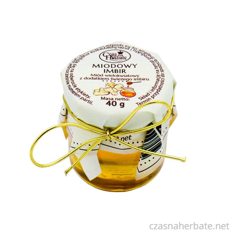 Słoiczek miodowego imbiru z etykietą obwiązaną złotą gumką na wieczku