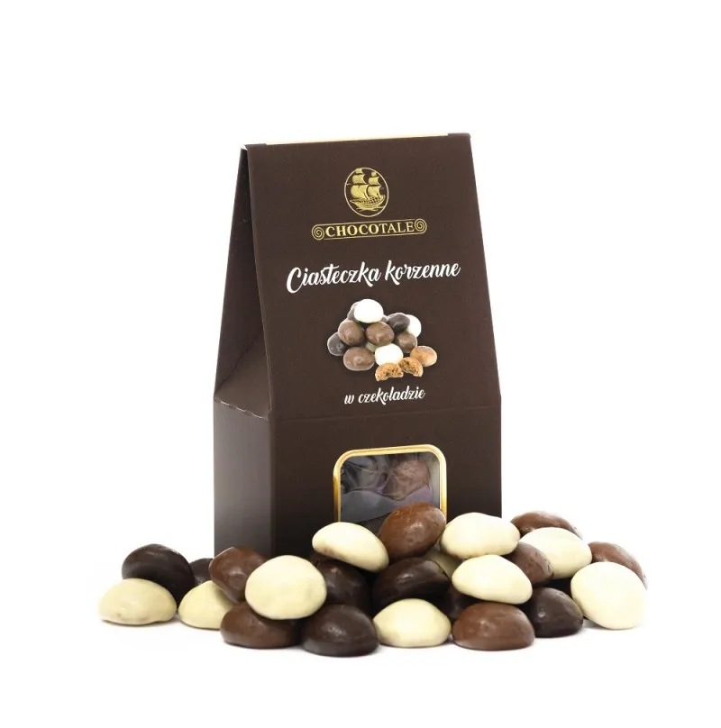 Brązowy kartonik z kwadratowym okienkiem, obok ciasteczka korzenne w czekoladzie