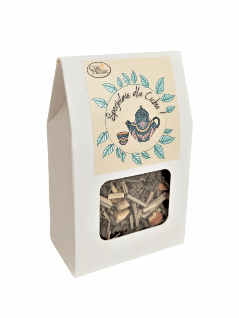 Widok z boku na jasne opakowanie z kwadratowym okienkiem i żółtą etykietą z rysunkiem wianka z liści