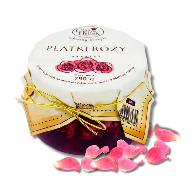 Słoiczek z białą etykietą nałożoną na wieczko i obwiązaną złotą gumką, obok płatki róży