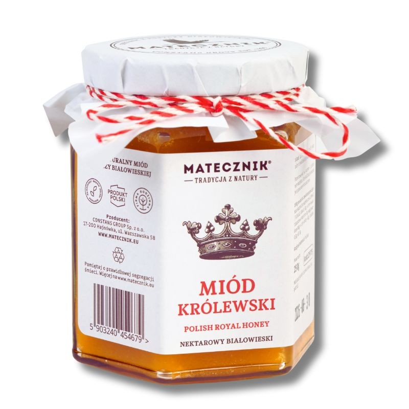 Sześciokątny słoik miodu królewskiego z białą naklejką i etykietą wokół zakrętki obwiązaną biało-czerwonym sznurkiem