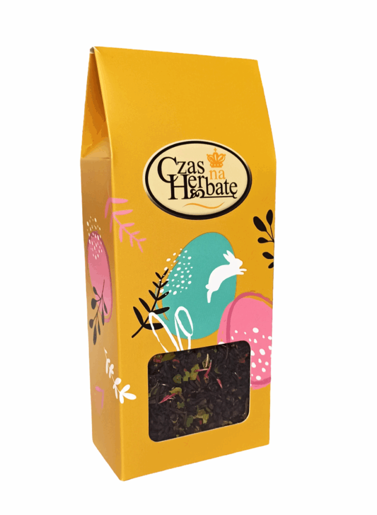 Żółte opakowanie herbaty Czas na Herbatę z motywem pisanek, z okienkiem ukazującym liściastą mieszankę.