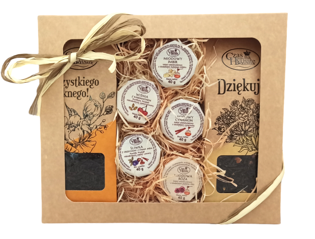 Widok z przodu na zestaw prezentowy w ozdobnym pudełku z okienkiem: 4 słoiczki konfitur i miodów i dwie torebki herbaty, całość przewiązana wstążką.