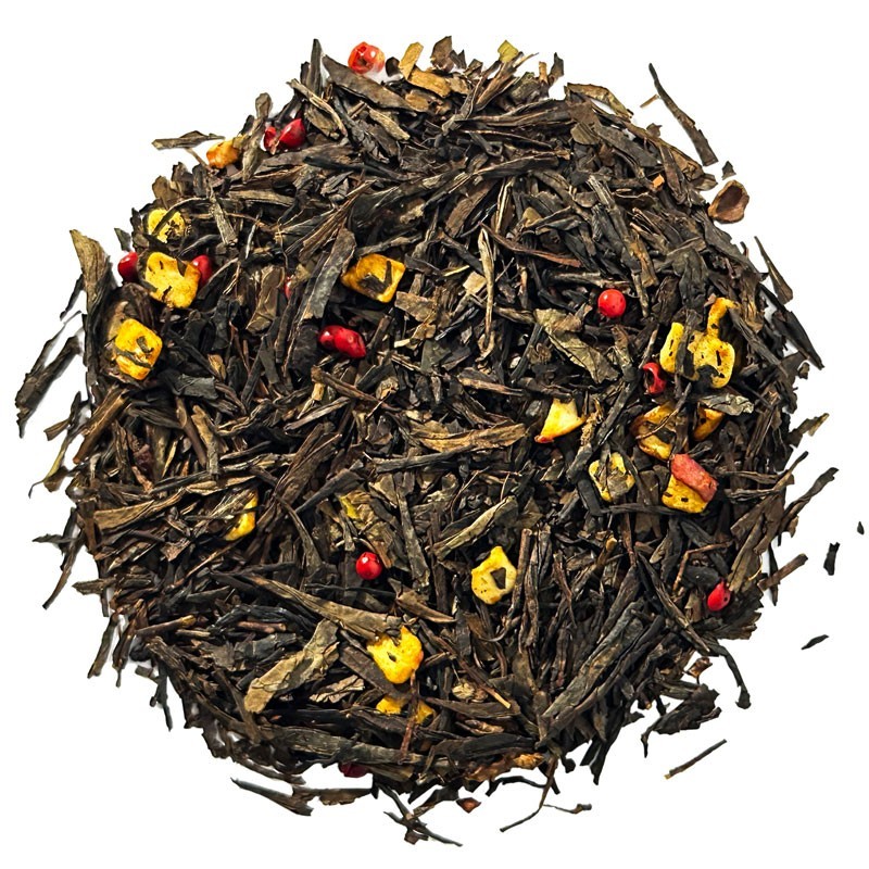 Top view of sencha green tea with exotic fruit pieces and red pepper.