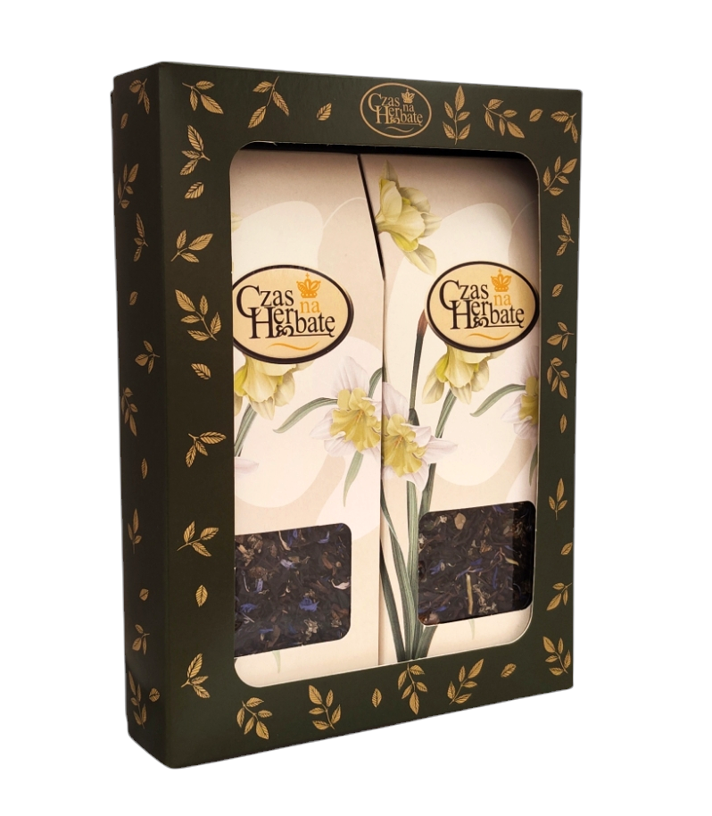 Widok z boku na zestaw prezentowy dwóch herbat w eleganckim pudełku z okienkiem, motywem żółtych narcyzów oraz złotymi zdobieniami na ciemnym tle.
